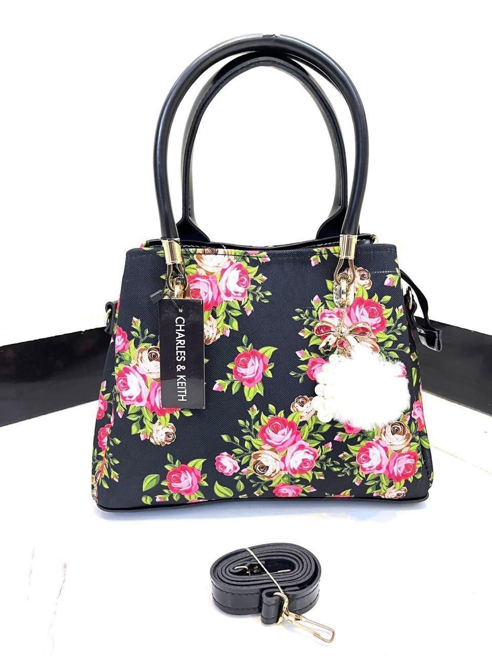Elegant Floral Pattern Handbag with Stylish Handle and Charm Accent